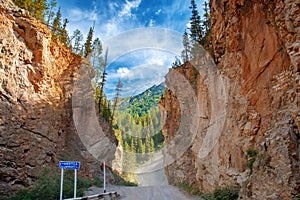 Road through narrow passage in the rocks. Red Gate on the Chibit River.