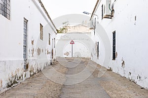 Road narrows sign in the end of the road