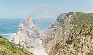 Road next to a stunning beach and awe-inspiring cliffs overlooking the ocean