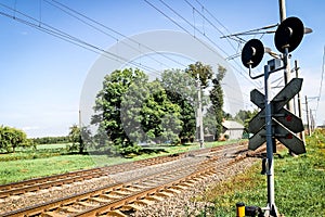 Road with old railway crossing and signs