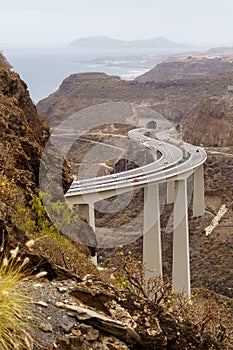 road over huge bridge bordering the mountains by the sea on the island of Gran Canaria. Spain, Europe