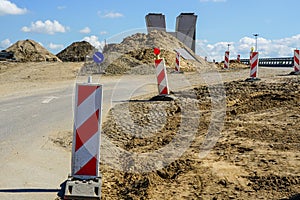 Road overpass concrete bridge construction site view with concrete support and traffic warning signs