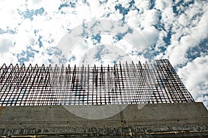 Road overpass under construction on the highway. A viaduct support against a cloudy sky