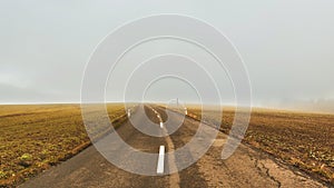 Road panorama on foggy autumn day outdoors, empty asphalt