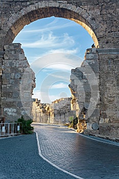 Road passes through the ancient Vespasian Gate in Side, Turkey