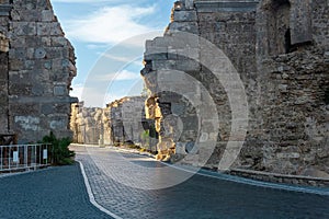 Road passes through the ancient Vespasian Gate in Side, Turkey