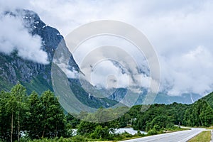 Road passing a large mountain peak in Norway