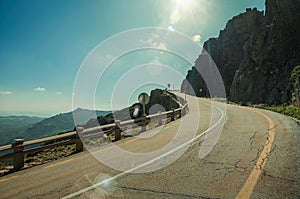 Road passing through rocky landscape in a sunny day