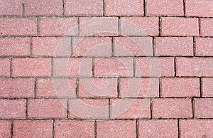 Road paved with brown sidewalk tiles. texture of light gray bricks