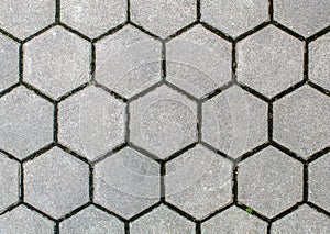 Road paved with hexagonal sidewalk tiles. texture of light gray bricks