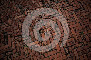 The road is paved with red bricks. Background, texture of the road tiles