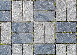 Road paved with sidewalk tiles. texture of light and dark gray bricks