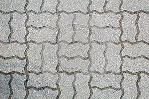 Road paved with sidewalk tiles. texture of light gray bricks