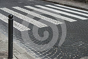Road from paving stones and pedestrian crossing