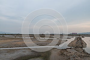 A road piled up on saline alkali land, a salt pond