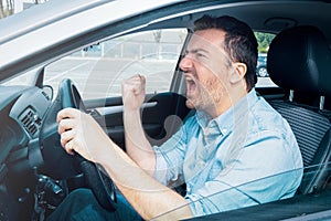 Road rage man at the wheel threatening other drivers