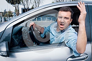 Angry and rude man driving his car feeling stressed