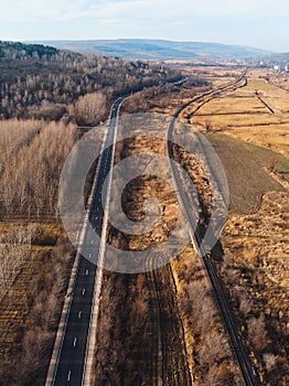 Road and railway line in field
