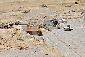 Road and rain drain in the city during renovation and modernization. Summer. Day
