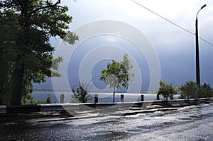 Road after rain near the river. Severe weather befor storm