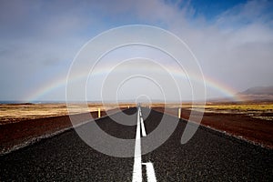 Road and rainbow, low angle view