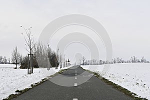 Road raked by snow plough in winter. Roads cleared by plough in winter. Concept of winter and winter road care