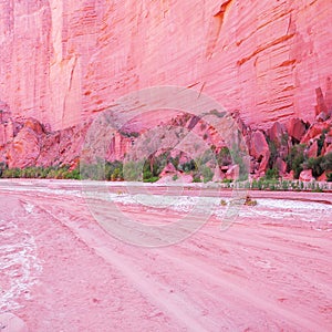 Road and red rock on the bottom of the canyon.