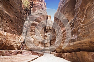The road between the red rocks of the Siq gorge to the ancient city of Petra,