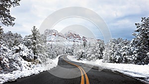 Road through red rocks with snow in Sedona, Arizona