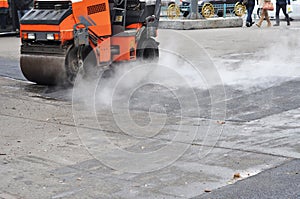 Road repair, compactor lays asphalt. Roadworks on laying of a sphalt. Repair pavement and laying new asphalt patching method