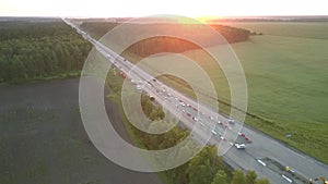 Road repair at pictorial farmland at sunset aerial panorama