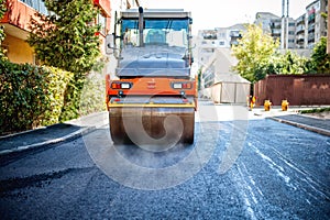 Road repairing in urban modern city with heavy vibration roller