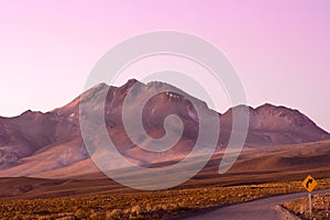 Road and road sign in the Altiplano High Andean plateau, Atacama desert, Chile