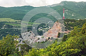 Road through the rock with a cell tower on top