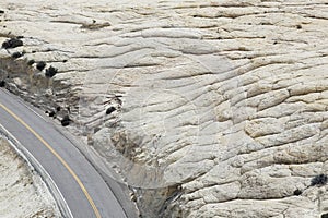 Road through rock formation in desert elevated view