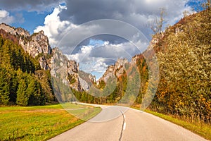 Road through a rocky gorge in a mountain valley at autumn