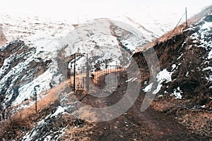 The road in the rocky mountains against the mountains with snow