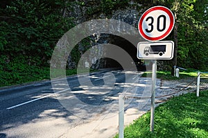 Road rocky tunnel with 30 speed limit sign in Bled, Slovenia