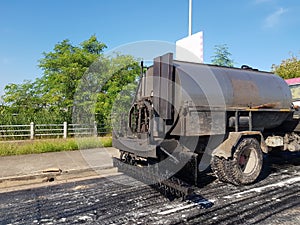 Road roller and asphalt compactor parked on the side of the road during lunch break