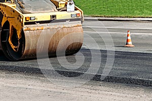 Road roller building new asphalt road at a road construction site