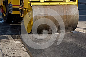 A road roller compacting asphalt.