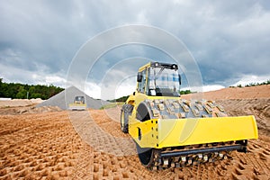 Road roller compacting soil