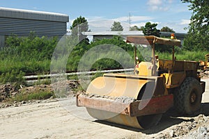 Road Roller Construction works on new road, preparing before asphalt compaction work. Big yellow