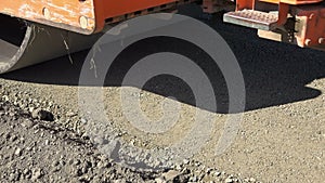 Road roller leveling ground at construction site.