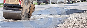 Road roller makes the paving.Close view on the road roller working on the road construction site