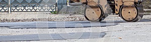 Road roller makes the paving.Close view on the road roller working on the road construction site