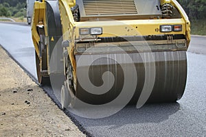 Road roller makes the paving