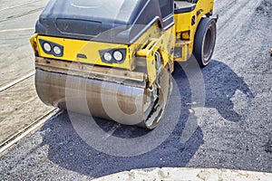 Road roller working near the curb