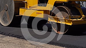 Road roller works on the construction of a new asphalt road. Road repair. Making new road. Transport problem concept