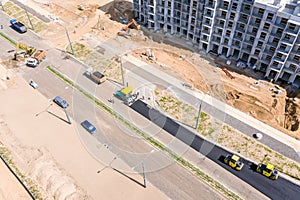 Road rollers doing asphalt pavement works. top view of construction site